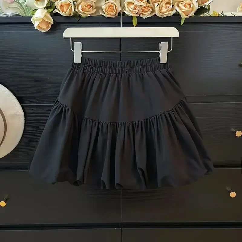 Gonna a bocciolo di fiore nera alla moda a vita alta da donna Torta a mezza lunghezza Minigonna gonfia alla moda Tinta unita semplice 1